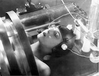 an old photo of a woman laying in a machine